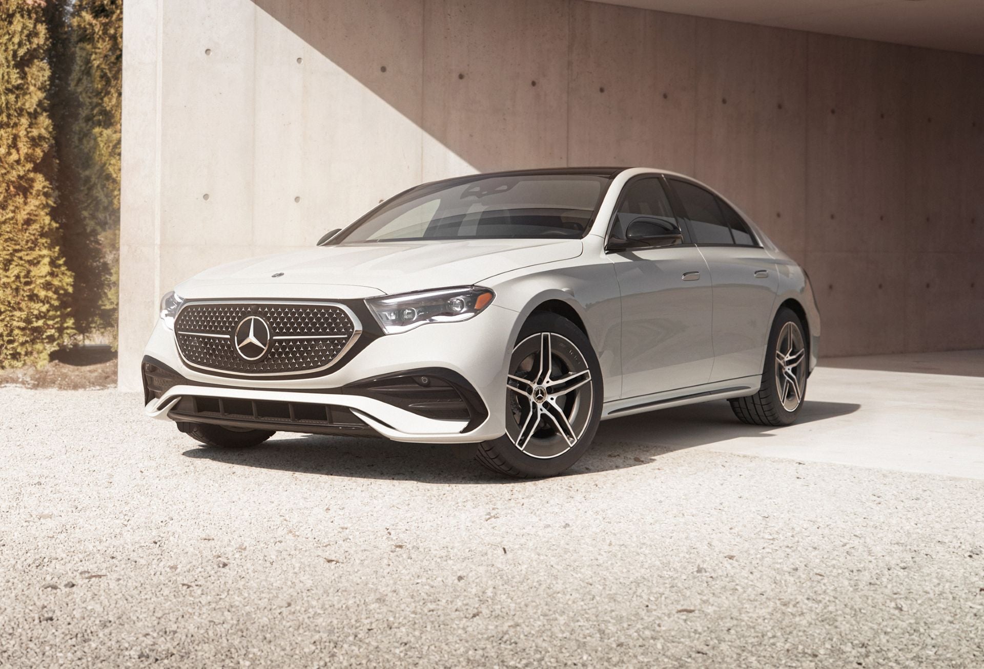 Mercedes-Benz E-Class Sedan parked next to an industrial building