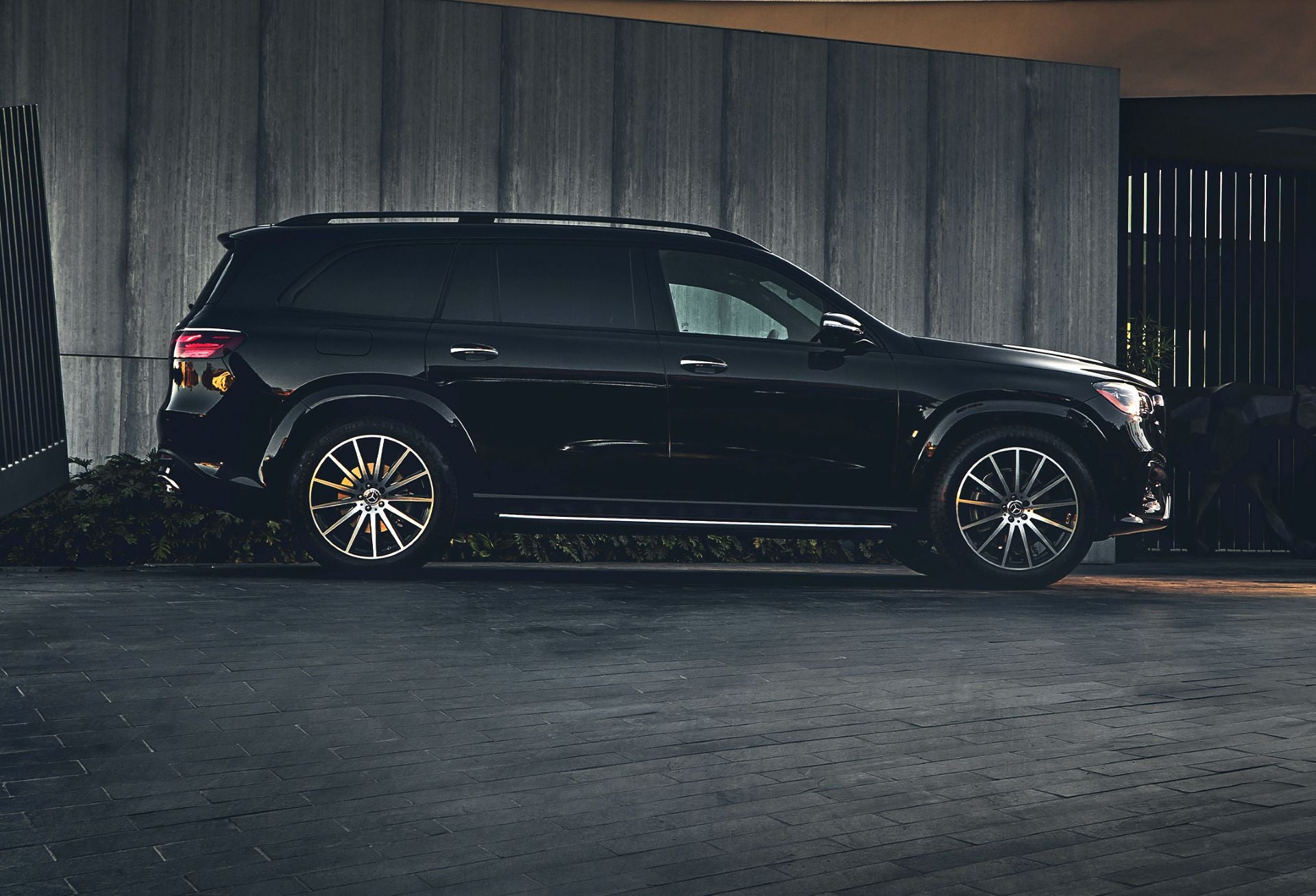 Mercedes-Benz GLS three row luxury SUV parked in a scenic driveway