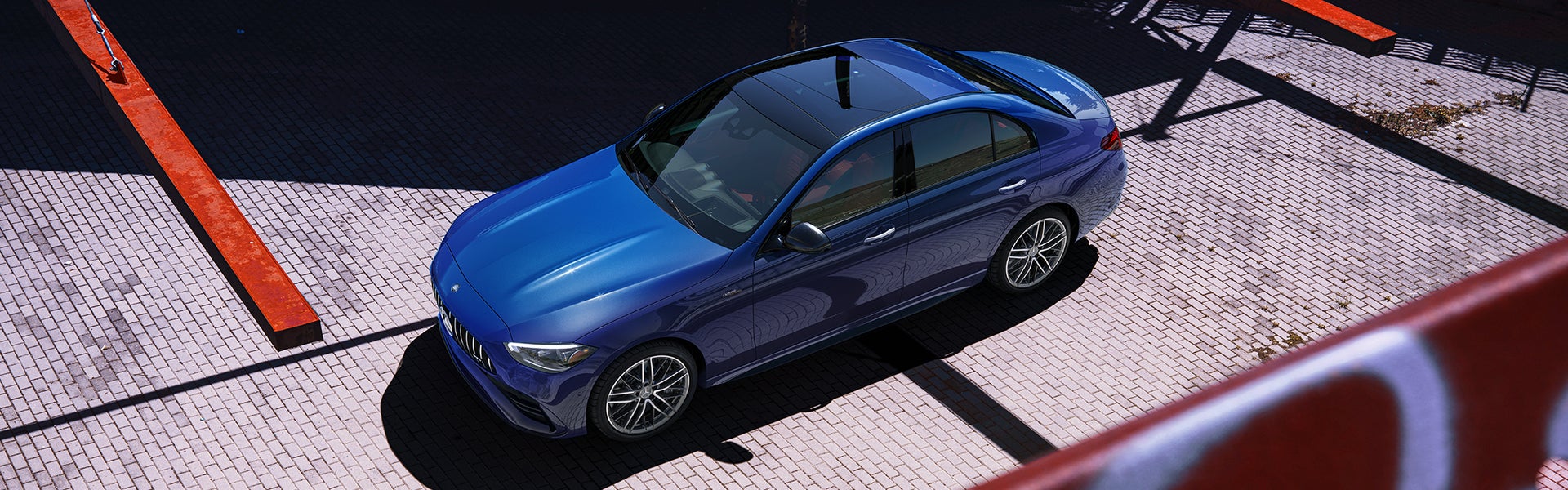 A white 2026 Mercedes-Benz C-Class parked in front of a house