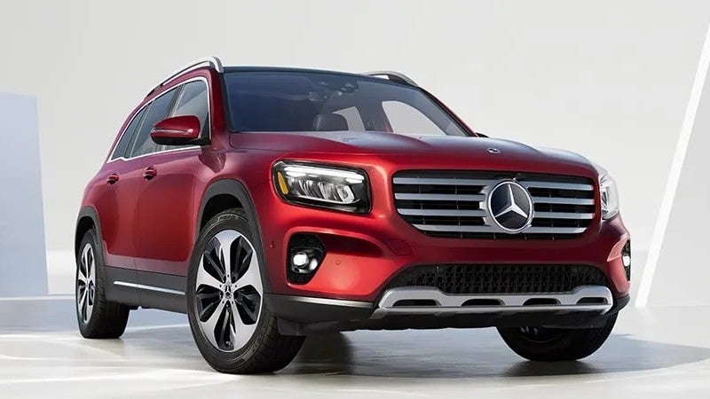 a red 2026 Mercedes-Benz GLB parked on a show room floor